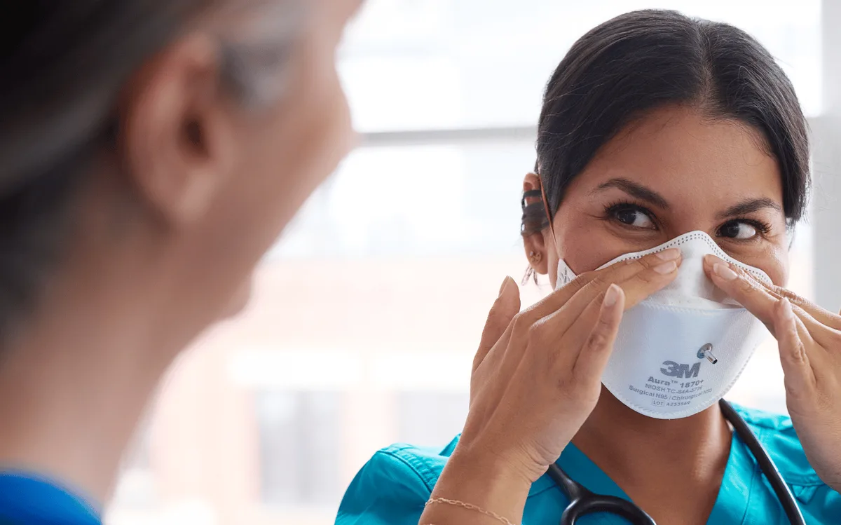 A healthcare professional wearing a respirator