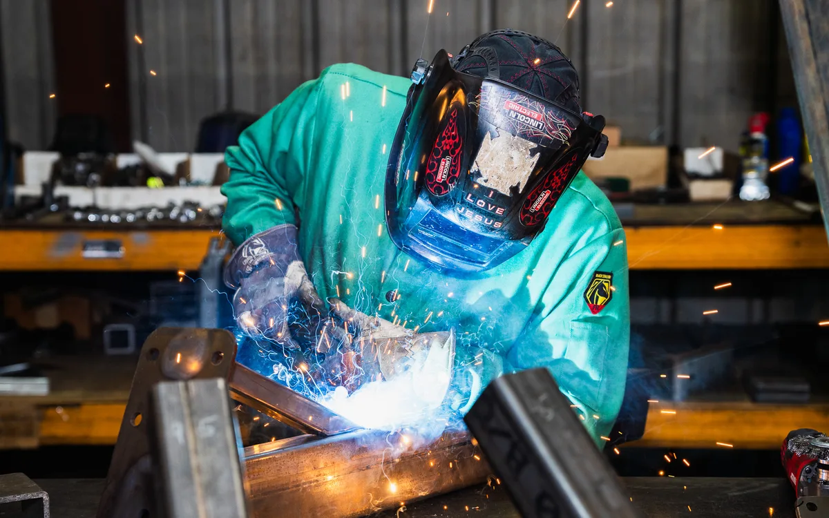 A Loadmaster team member welding in the workshop