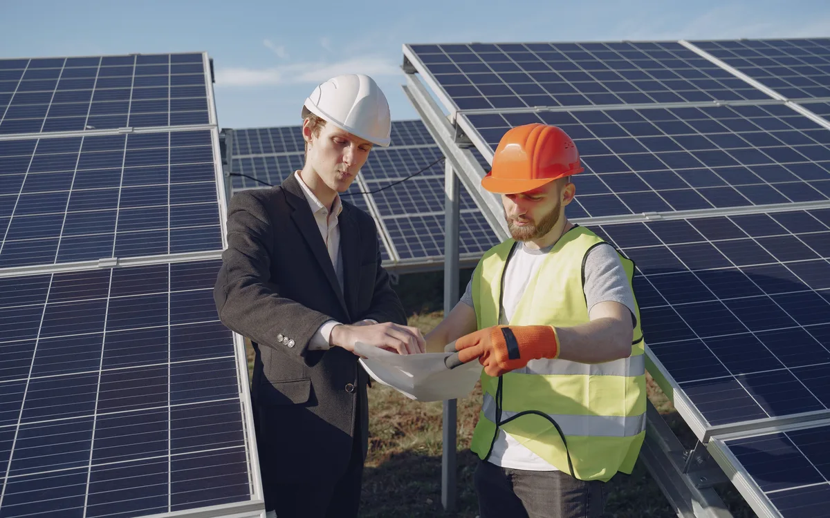 Illustrative stock: Energy professionals inspecting solar panels