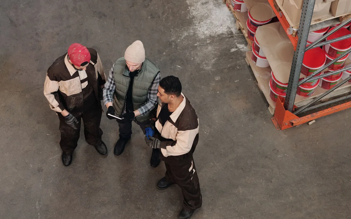 Illustrative stock: A warehouse team reviewing inventory