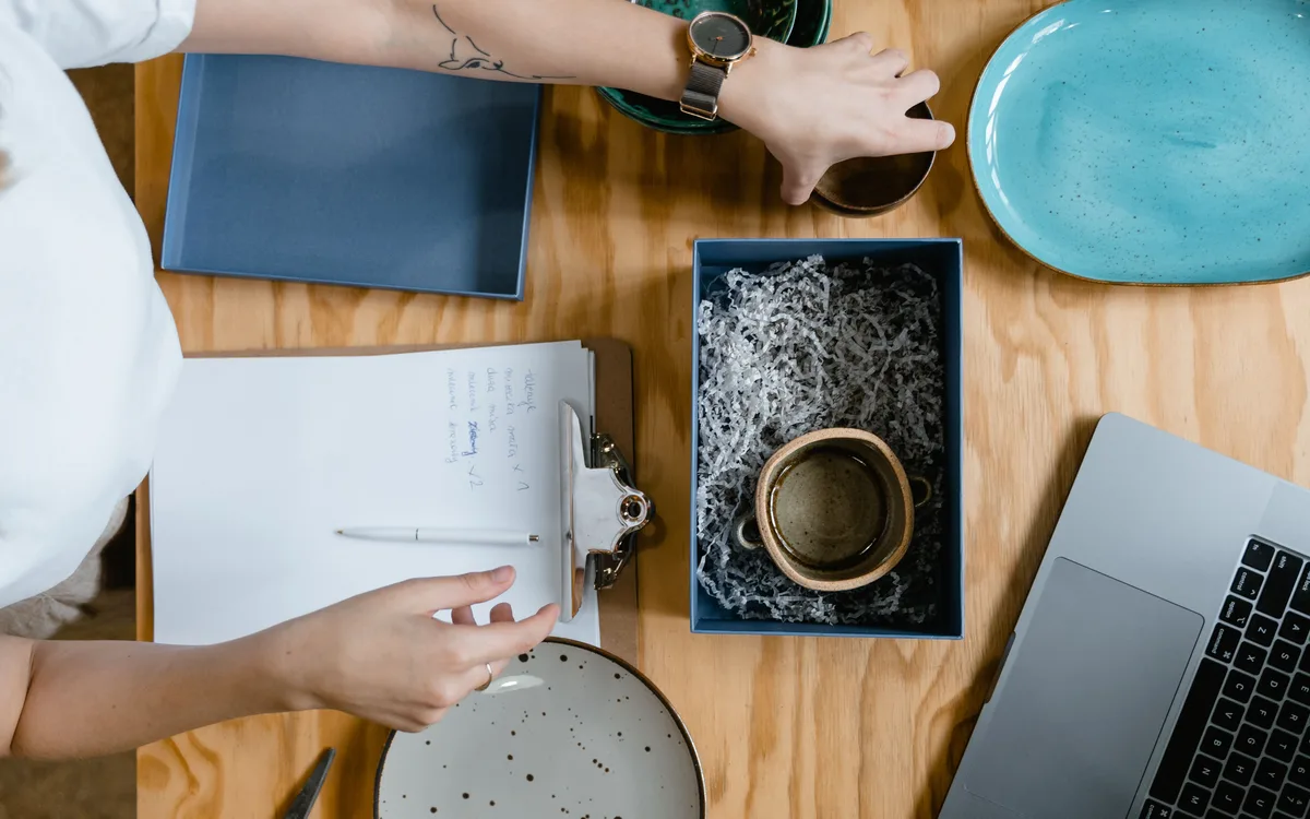 Illustrative stock: A seller preparing a ceramic mug for shipping